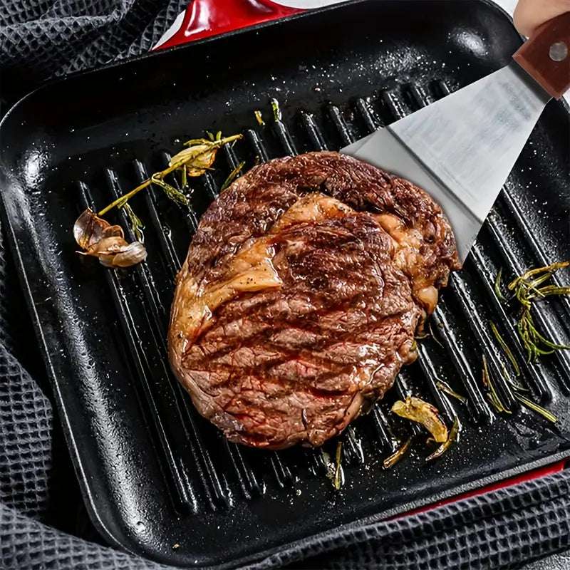 Une côte de bœuf parfaitement grillée sur une plancha, accompagnée d'ail et de branches de romarin.